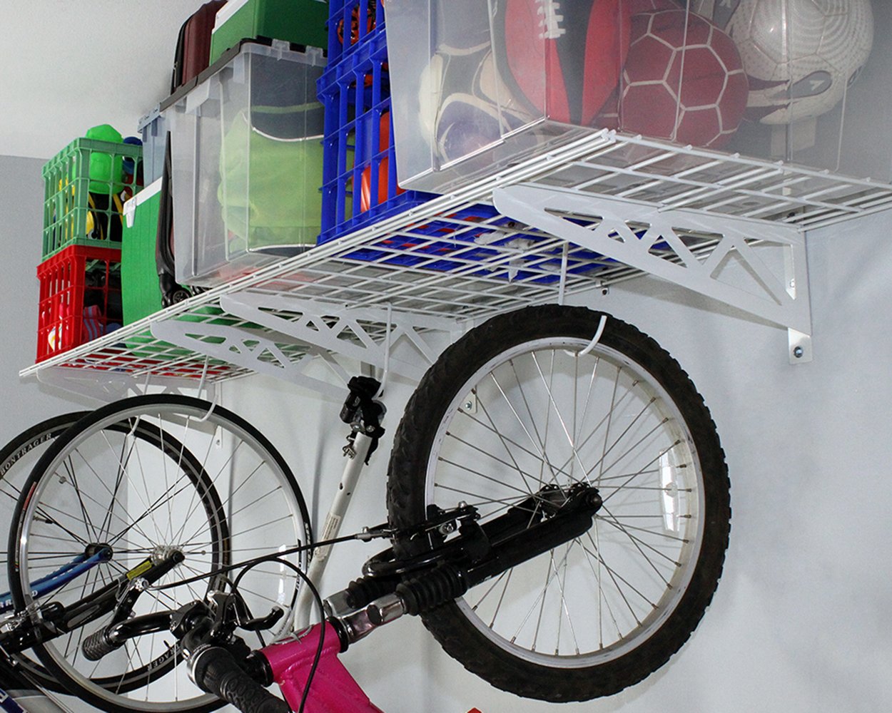 white wall shelves with bicycles and bins